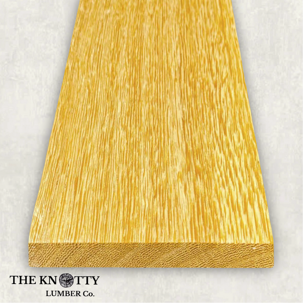 White Wenge 4/4, Otherwise known as Lati. A Wooden board with the grain and with 'The Knotty Lumber Co.' logo on a light grey background
