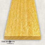 White Wenge 4/4, Otherwise known as Lati. A Wooden board with the grain and with 'The Knotty Lumber Co.' logo on a light grey background
