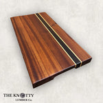 A Sapele cutting board with Wenge stripes, edges trimmed, displayed on a white background with The Knotty Lumber Co. branding.