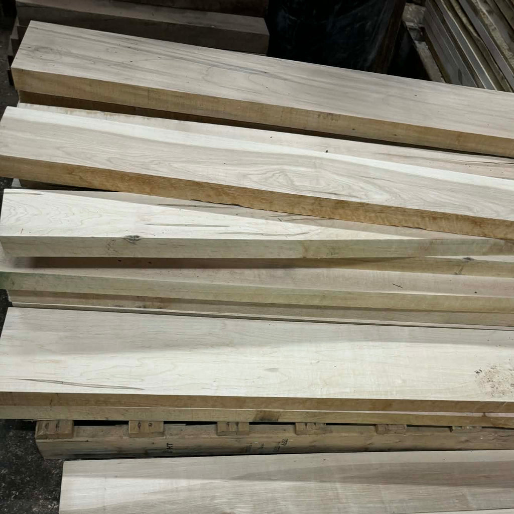 Stack of wooden planks on a dark surface