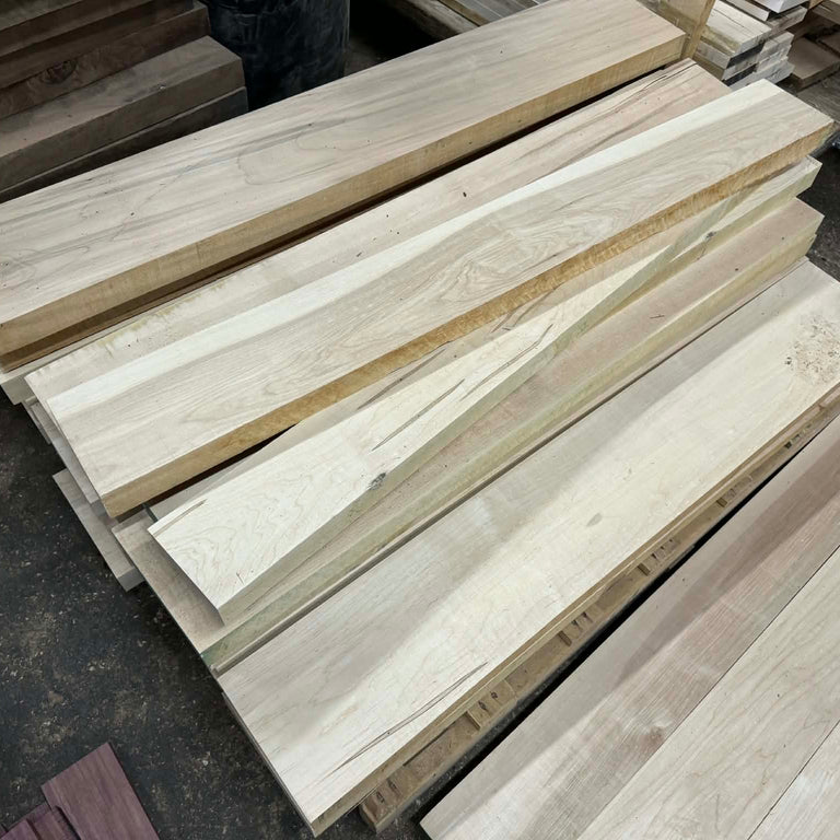 Stack of wooden planks on a dark surface