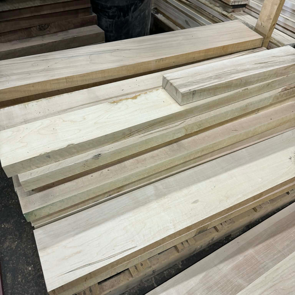 Stack of wooden planks with a person partially visible in the background