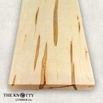 Ambrosia maple 4/4 hardwood image. A Wooden board with the grain and with 'The Knotty Lumber Co.' logo on a light gray background