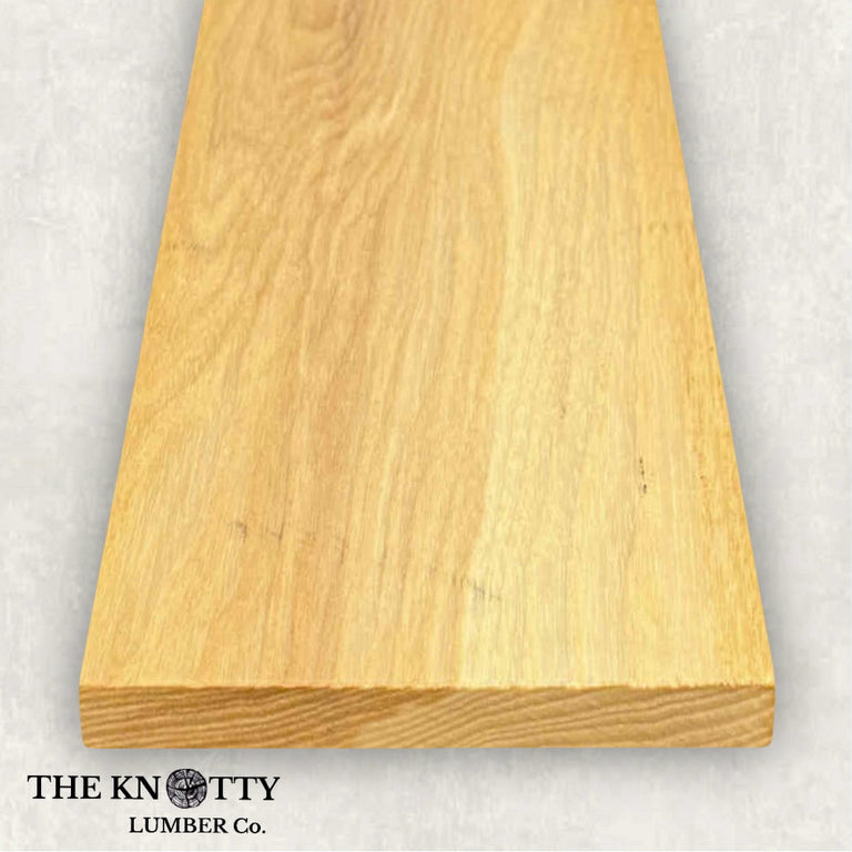 Ash 4/4 hardwood image. A Wooden board with the grain and with 'The Knotty Lumber Co.' logo on a light gray background