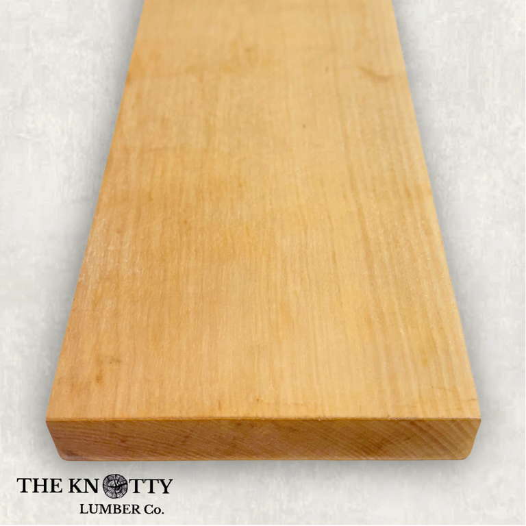 Yellow Birch 4/4, A Wooden board with the grain and with 'The Knotty Lumber Co.' logo on a light grey background