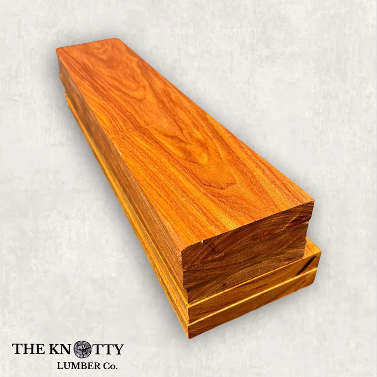 A lumber pack of Canarywood with a vibrant yellow to deep reddish brown color and a distinctive grain pattern.