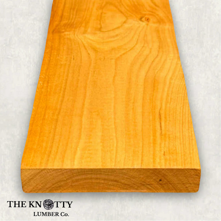 Cherry wood 4/4, A Wooden board with the grain and with 'The Knotty Lumber Co.' logo on a light grey background