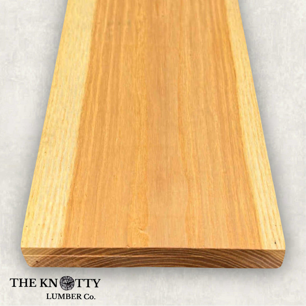 Hickory 4/4, A Wooden board with the grain and with 'The Knotty Lumber Co.' logo on a light grey background