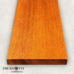 Merbau 4/4, A Wooden board with the grain and with 'The Knotty Lumber Co.' logo on a light grey background