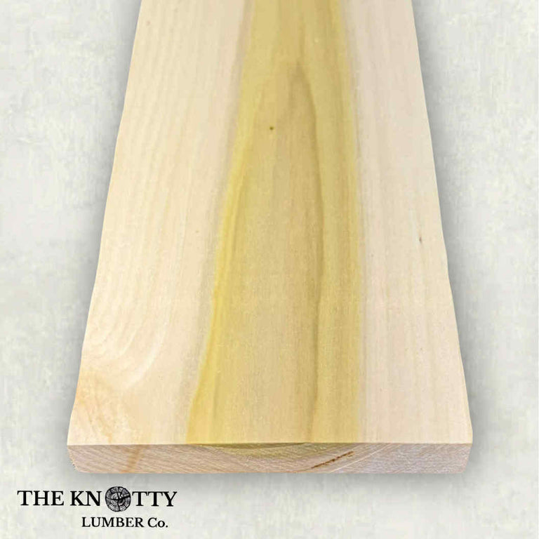 poplar Wooden board with visible white and green coloured grain texture on a light gray background, branded 'The Knotty Lumber Co'.