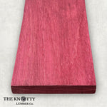 Purpleheart 4/4, A Wooden board with the grain and with 'The Knotty Lumber Co.' logo on a light grey background