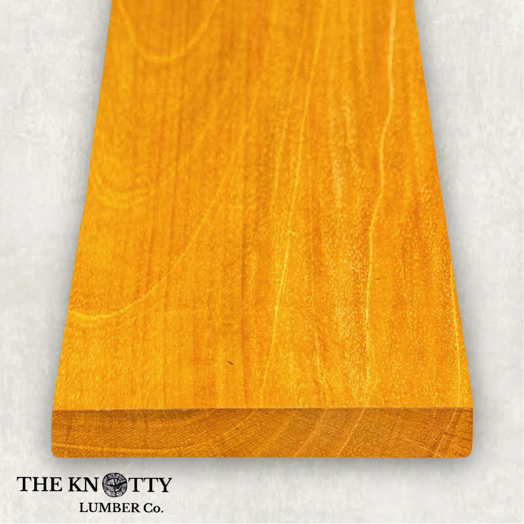 Spanish cedar 4/4 wood A Wooden board with the grain and with 'The Knotty Lumber Co.' logo on a light grey background