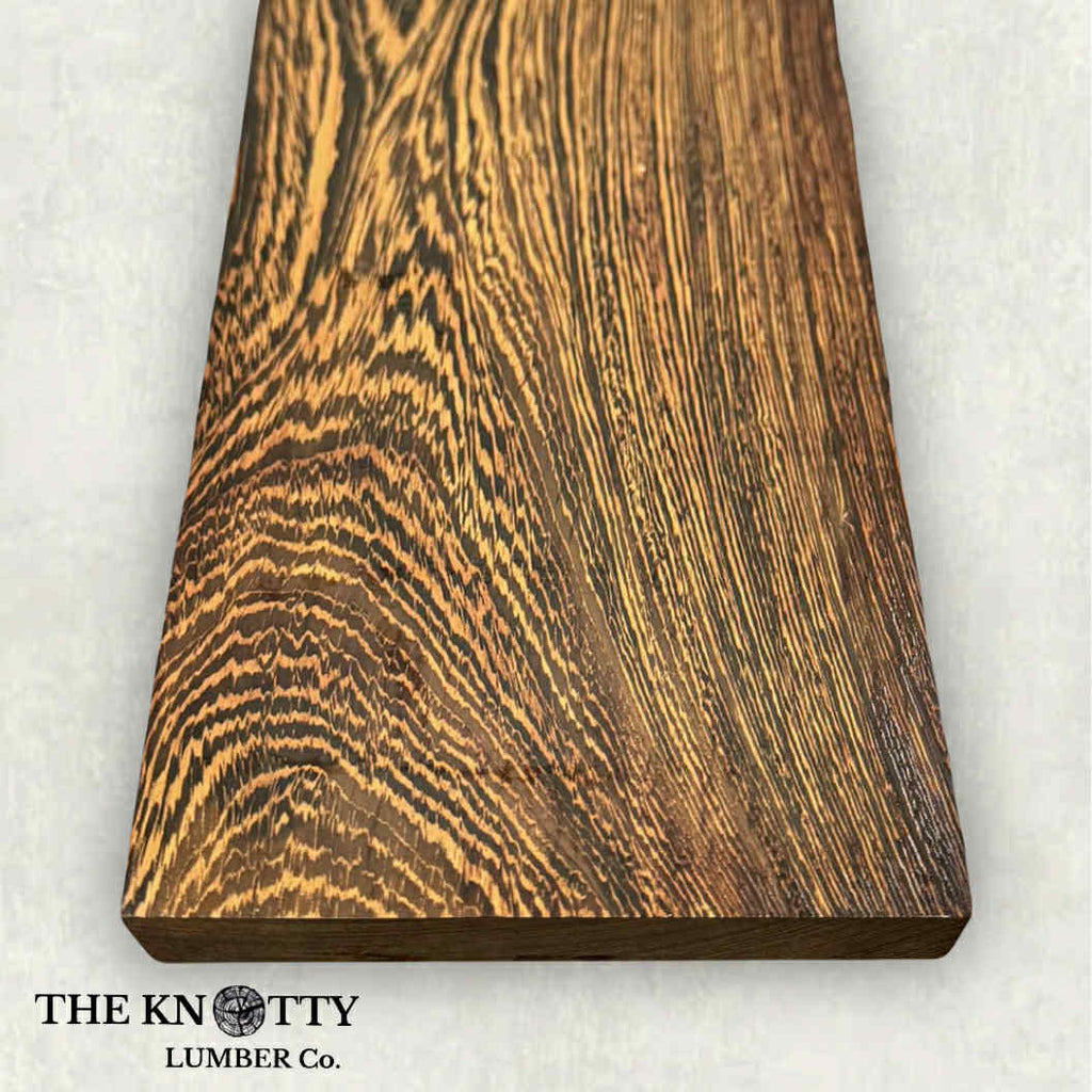 Wenge 4/4 Wooden board with visible grain pattern on a white background, branded 'The Knotty Lumber Co'.