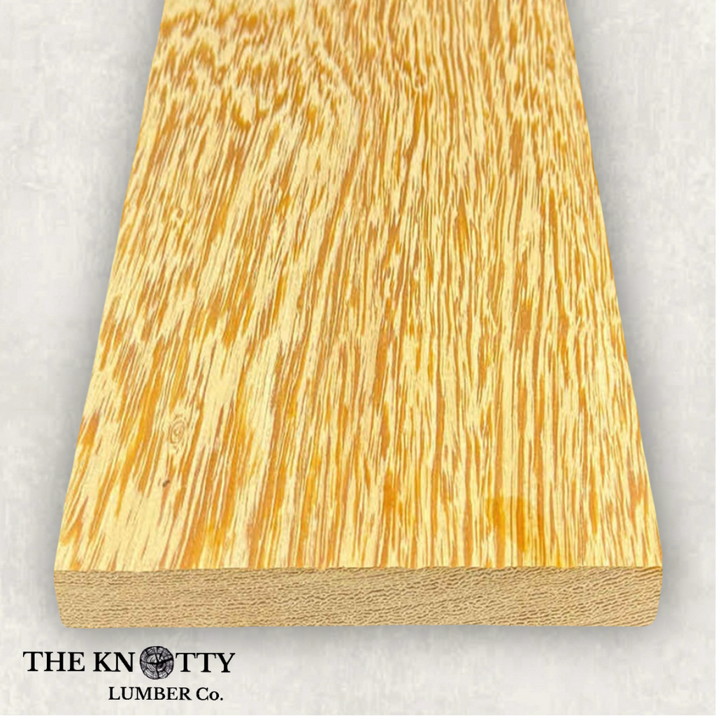 White Wenge 4/4, Otherwise known as Lati. A Wooden board with the grain and with 'The Knotty Lumber Co.' logo on a light grey background