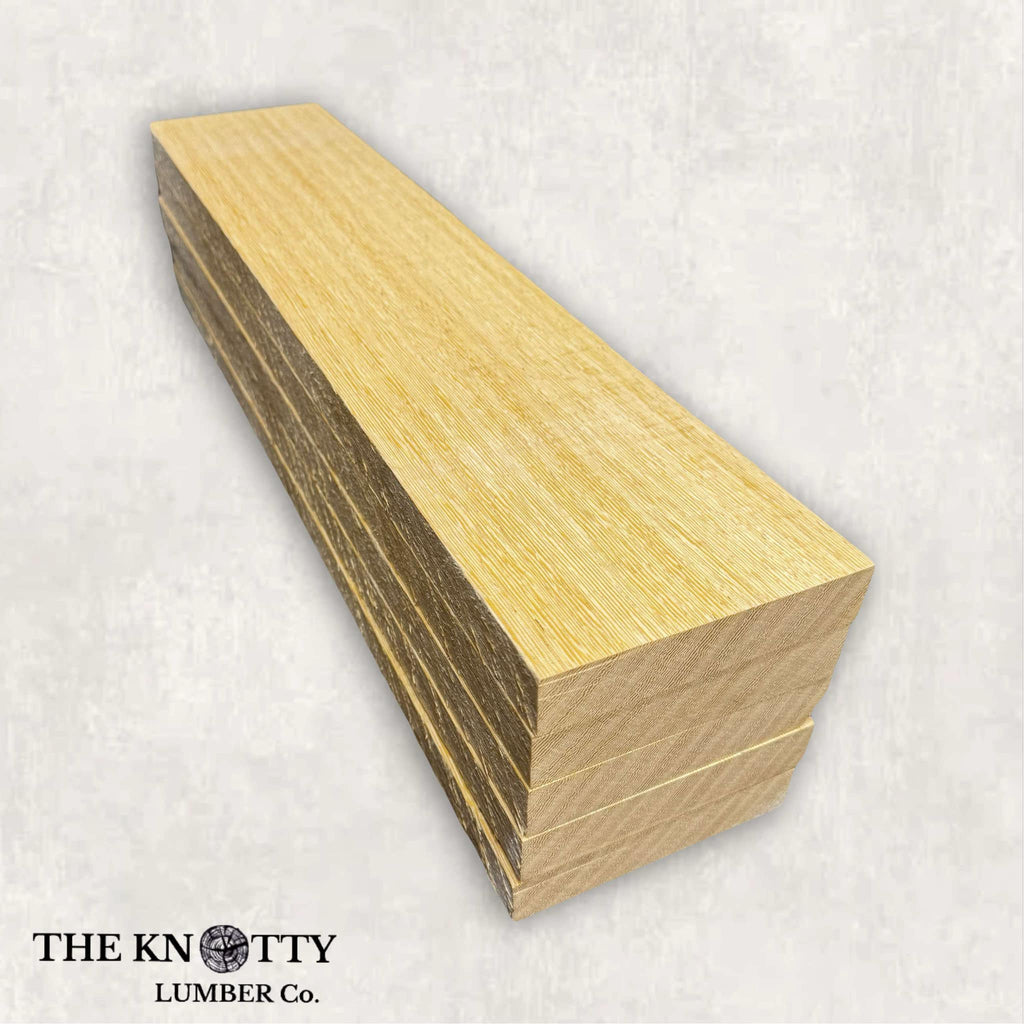 A lumber pack of white wenge with light golden-brown to pale cream tones and a fine-to-medium texture displayed on a white background.