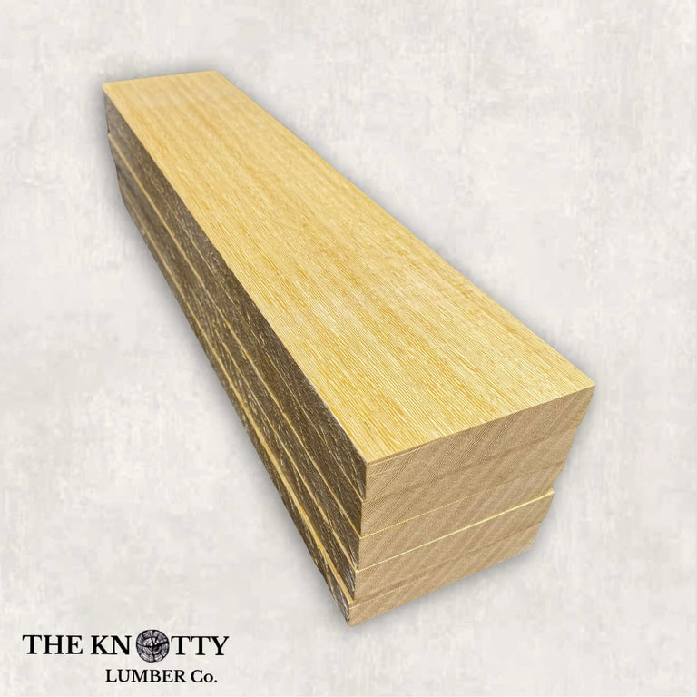 A lumber pack of white wenge with light golden-brown to pale cream tones and a fine-to-medium texture displayed on a white background.