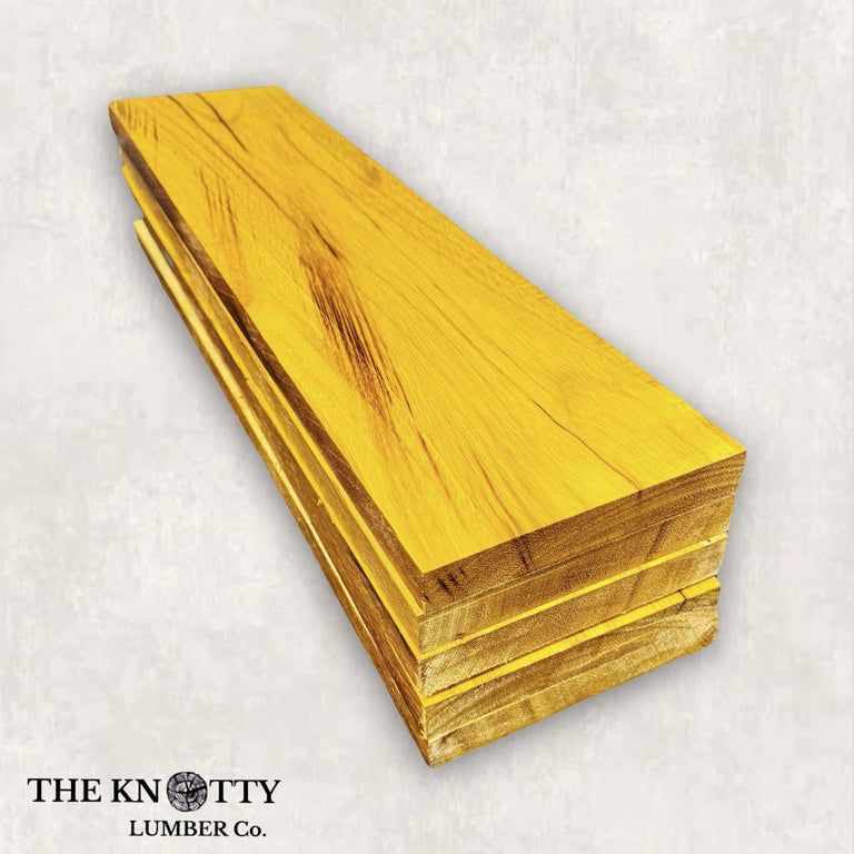 A lumber pack of yellowheart wood with a vibrant golden-yellow hue and fine grain texture, branded by THE KNOTTY LUMBER CO.